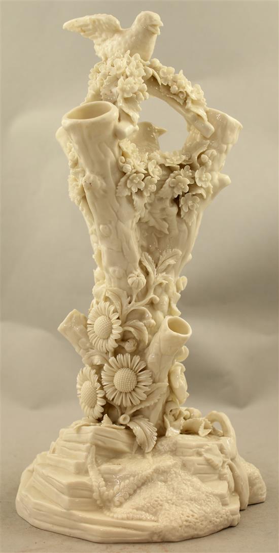 A Belleek bird and nest on a stump vase, late 19th century, 32cm, loss to bird
